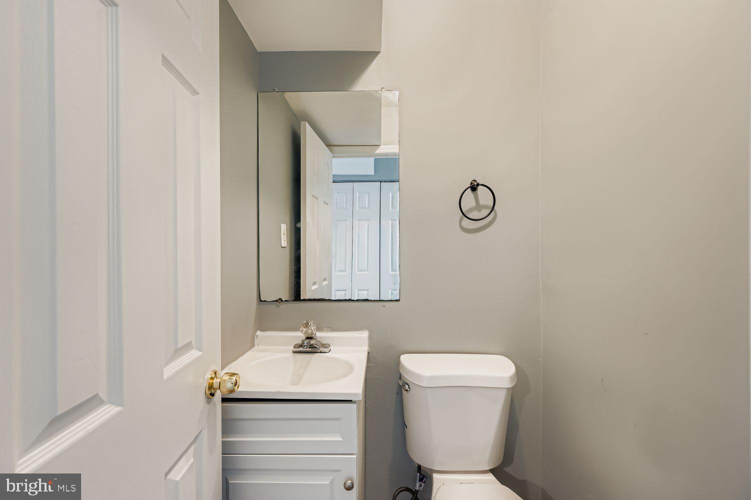 2610 Hallam Court, Unit 2610 Windsor Mill, MD 21244 - Photo 11 of 17 a bathroom with a toilet sink and mirror