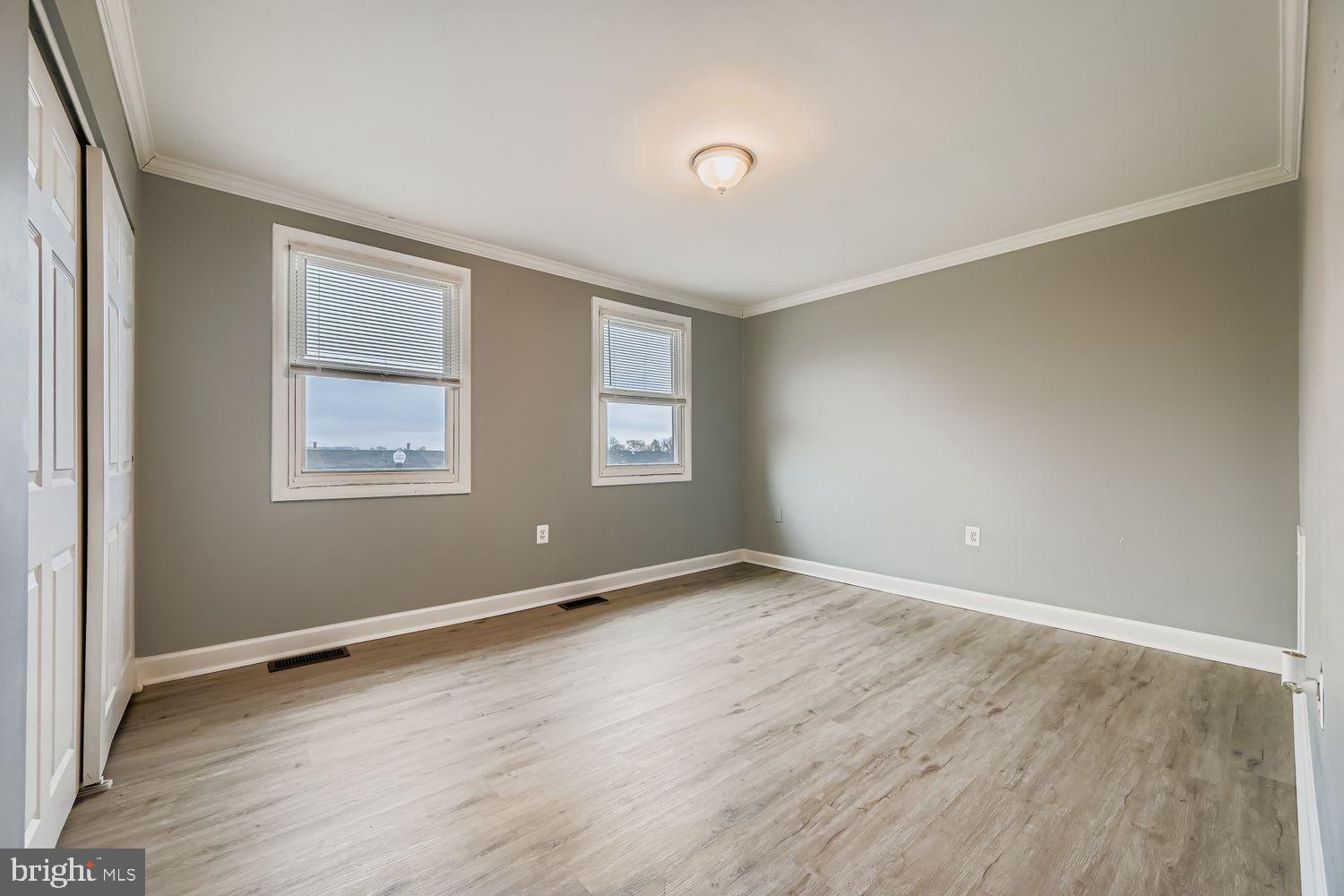 2610 Hallam Court, Unit 2610 Windsor Mill, MD 21244 - Photo 13 of 17 an empty room with wooden floor and windows
