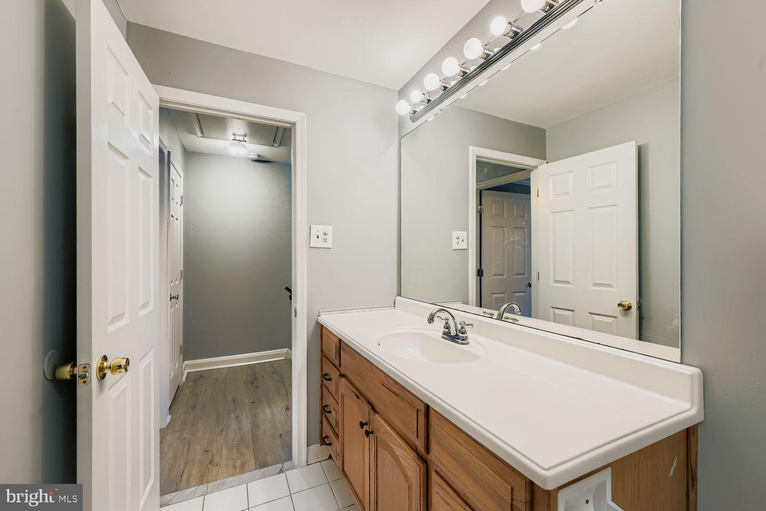 2610 Hallam Court, Unit 2610 Windsor Mill, MD 21244 - Photo 15 of 17 a bathroom with a sink a mirror and a shower