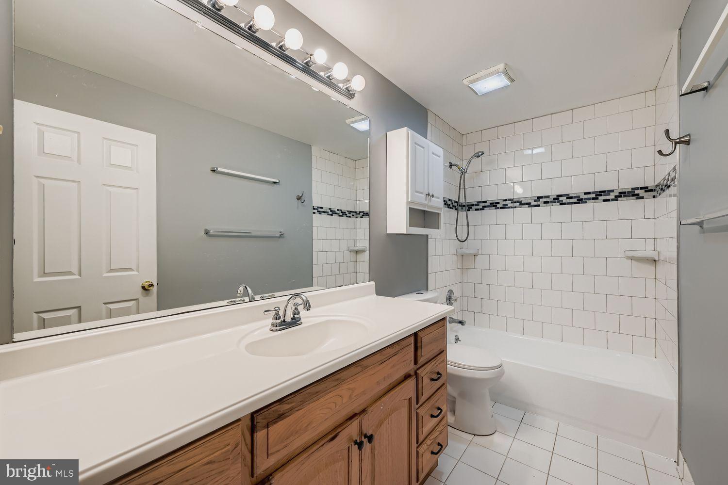 2610 Hallam Court, Unit 2610 Windsor Mill, MD 21244 - Photo 16 of 17 a bathroom with a sink a toilet a mirror and shower
