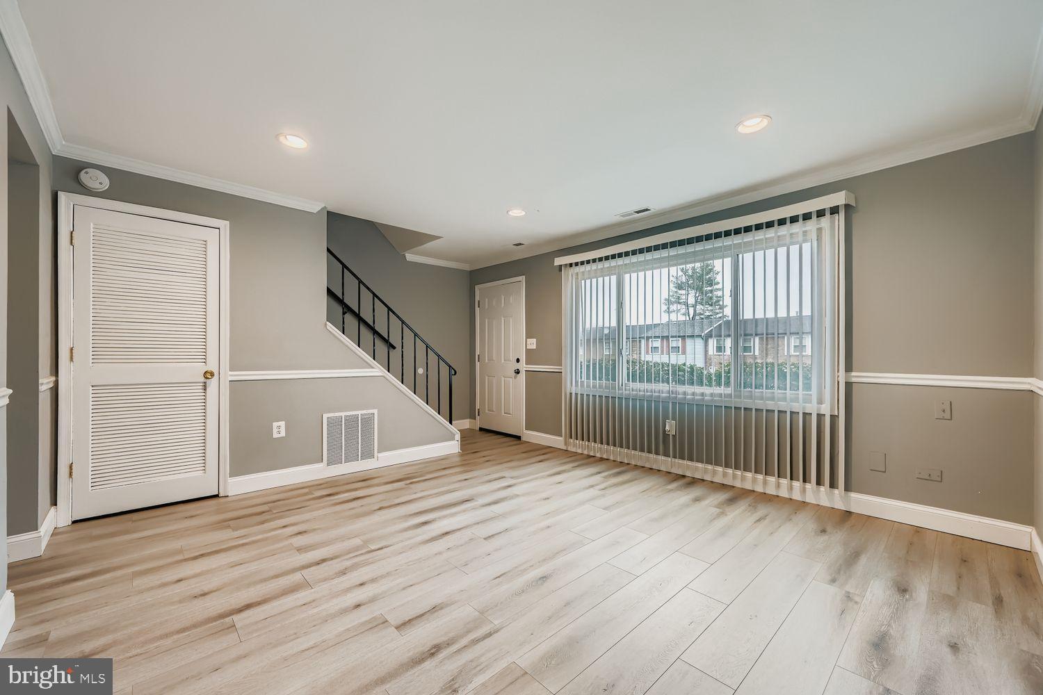 2610 Hallam Court, Unit 2610 Windsor Mill, MD 21244 - Photo 4 of 17 a view of empty room with wooden floor and fan