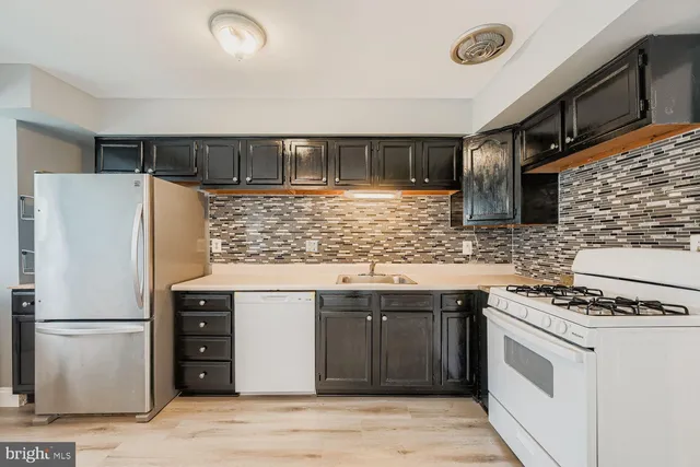 a kitchen with stainless steel appliances a refrigerator and a stove