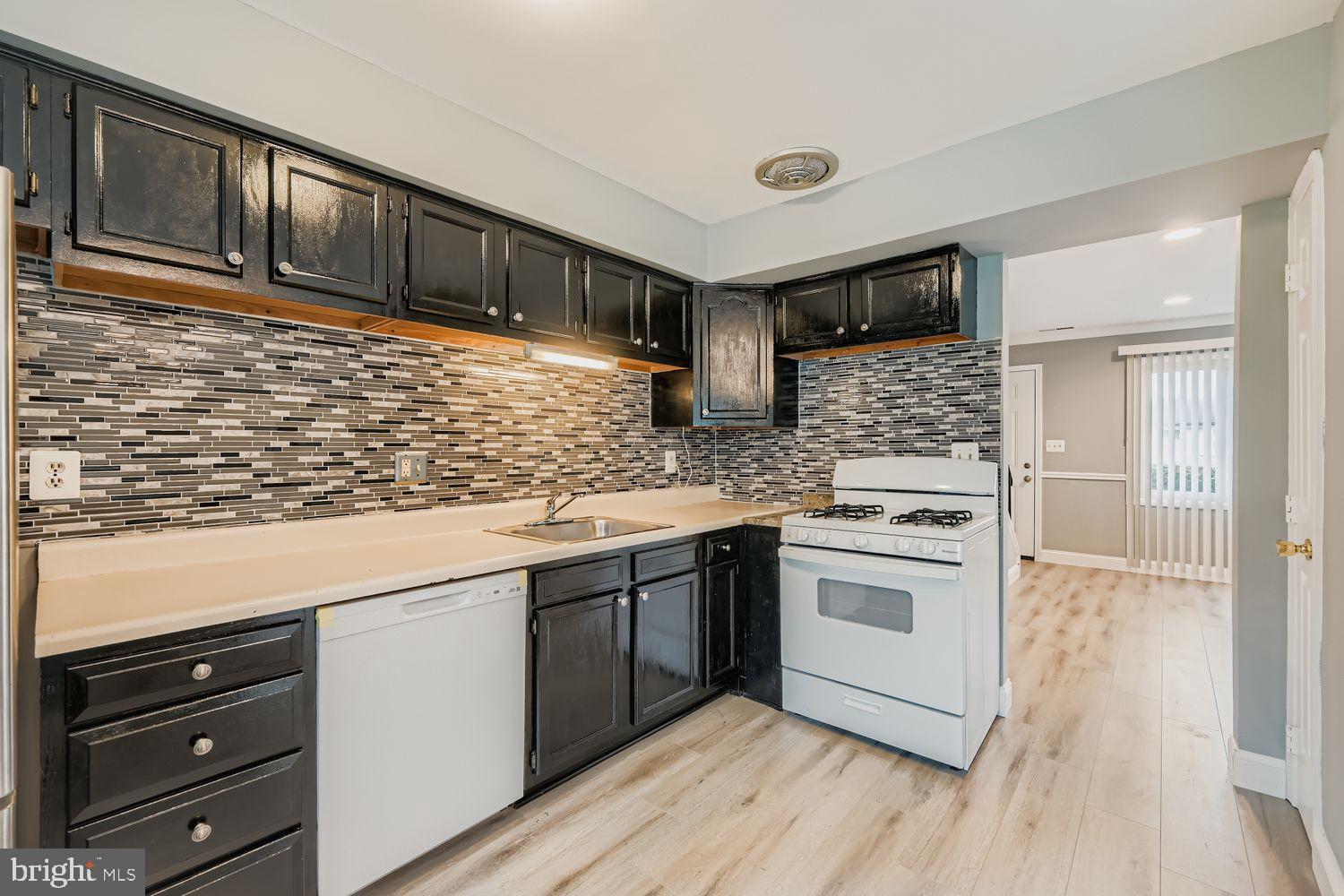 2610 Hallam Court, Unit 2610 Windsor Mill, MD 21244 - Photo 7 of 17 a kitchen with stainless steel appliances granite countertop a stove and a sink