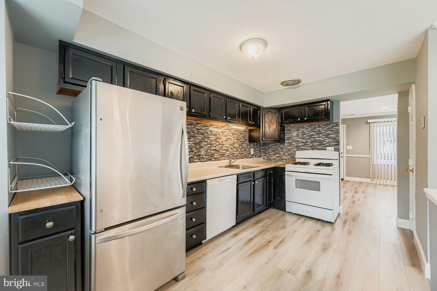 2610 Hallam Court, Unit 2610 Windsor Mill, MD 21244 - Photo 8 of 17 a kitchen with a refrigerator and a stove top oven