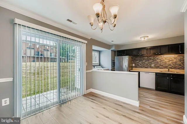 a view of kitchen with granite countertop cabinets and wooden floor