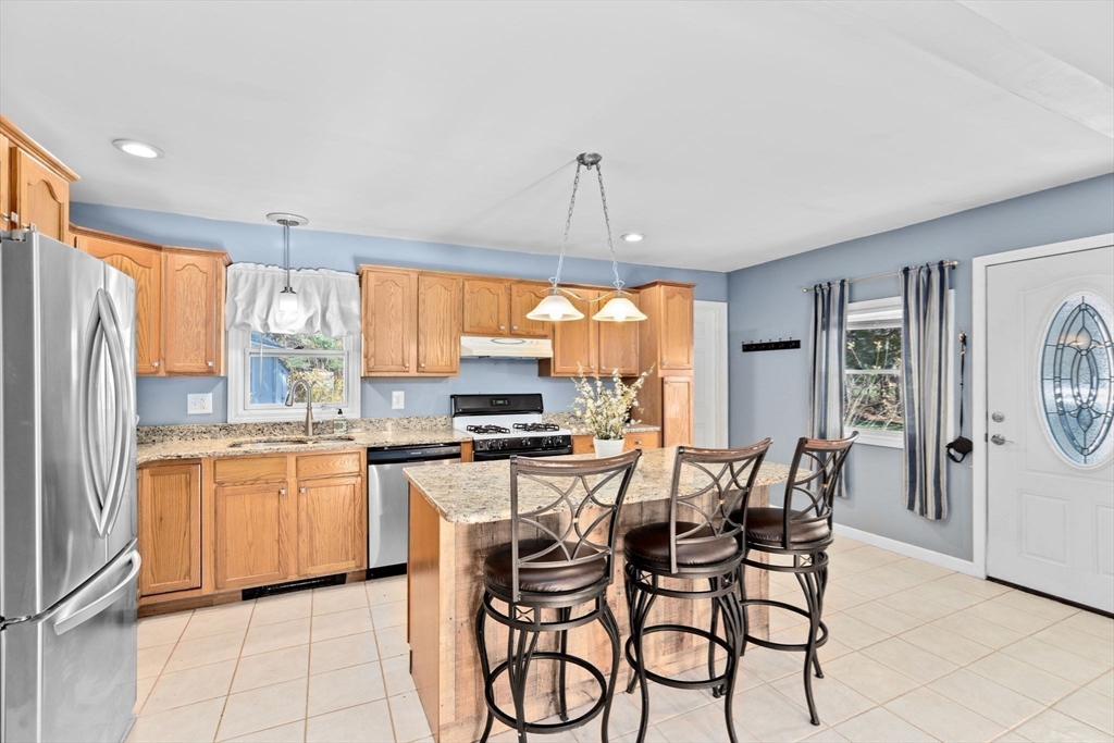 973 Point Road Marion, MA 02738 - Photo 1 of 33 a kitchen with stainless steel appliances a table chairs and a refrigerator