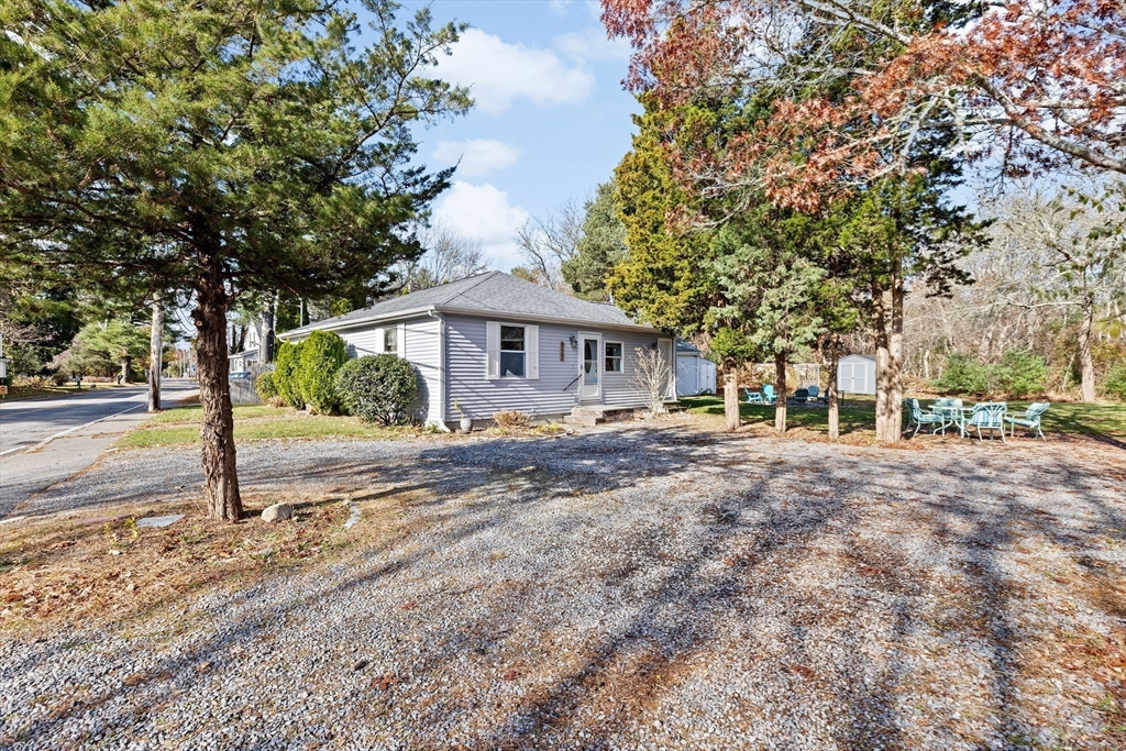 973 Point Road Marion, MA 02738 - Photo 5 of 33 a view of a house with a large tree and plants