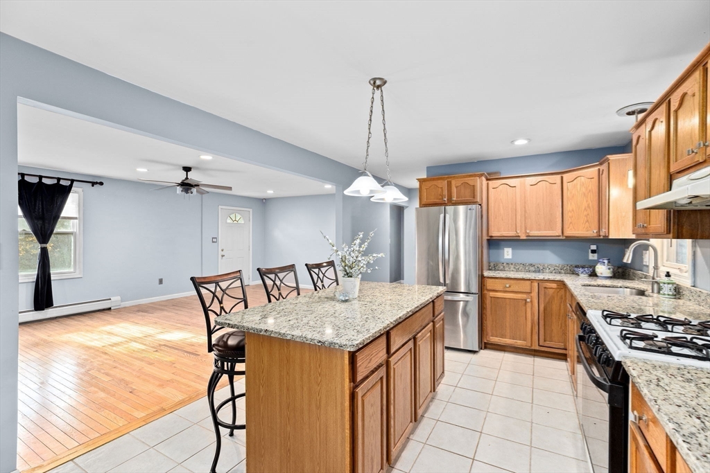 973 Point Road Marion, MA 02738 - Photo 8 of 33 a kitchen with stainless steel appliances granite countertop a sink stove and refrigerator