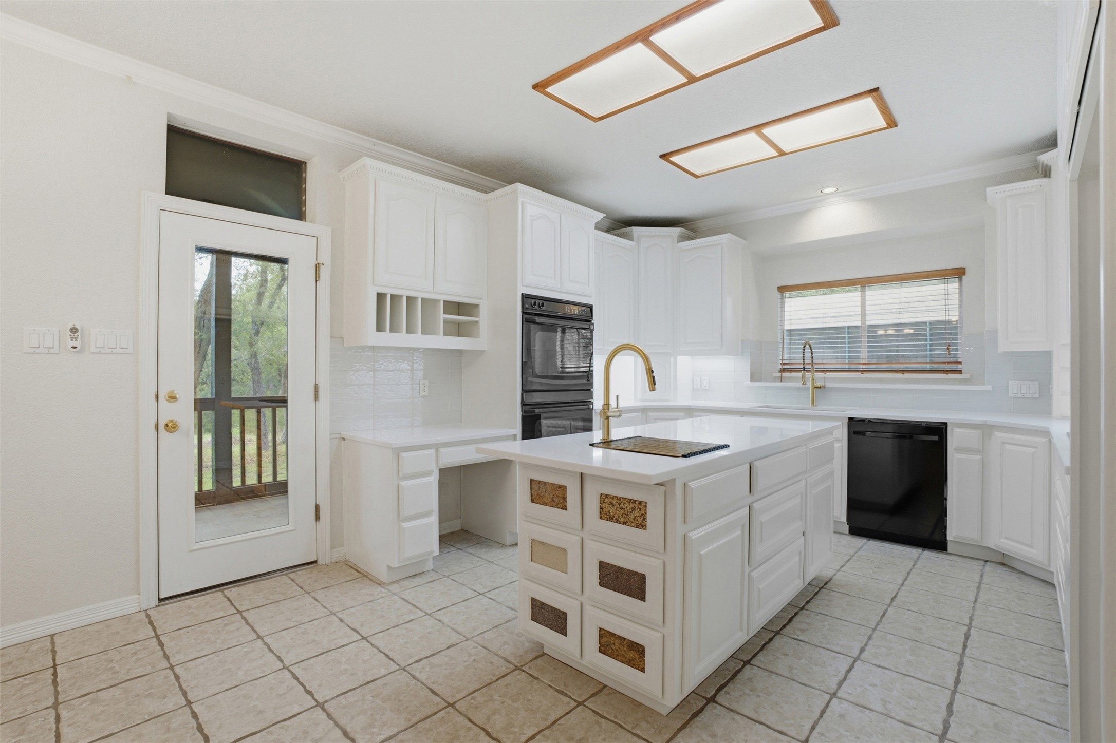1301 County Road 262 Georgetown, TX 78633 - Photo 14 of 39 Kitchen featuring white cabinetry, a central island with integrated storage, white countertops, and a subway tile backsplash