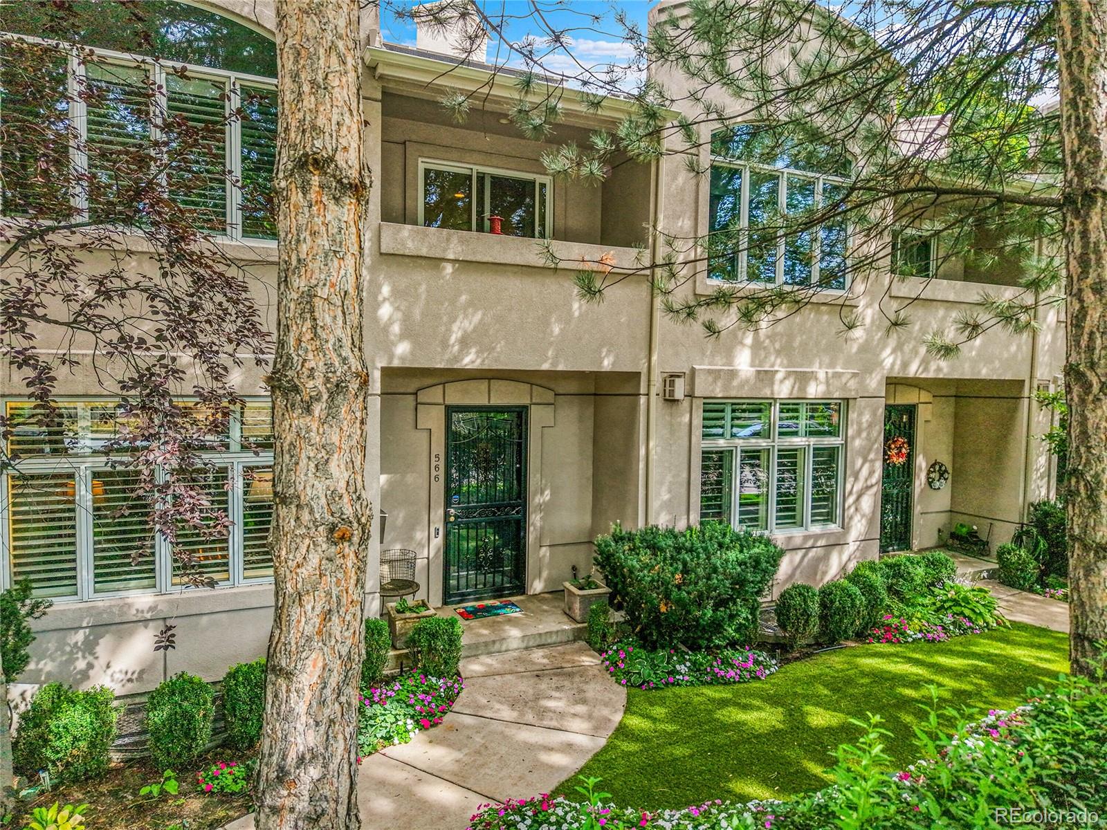 566 Josephine Street Denver, CO 80206 - Photo 36 of 45 a view of a house with brick walls and a yard with plants