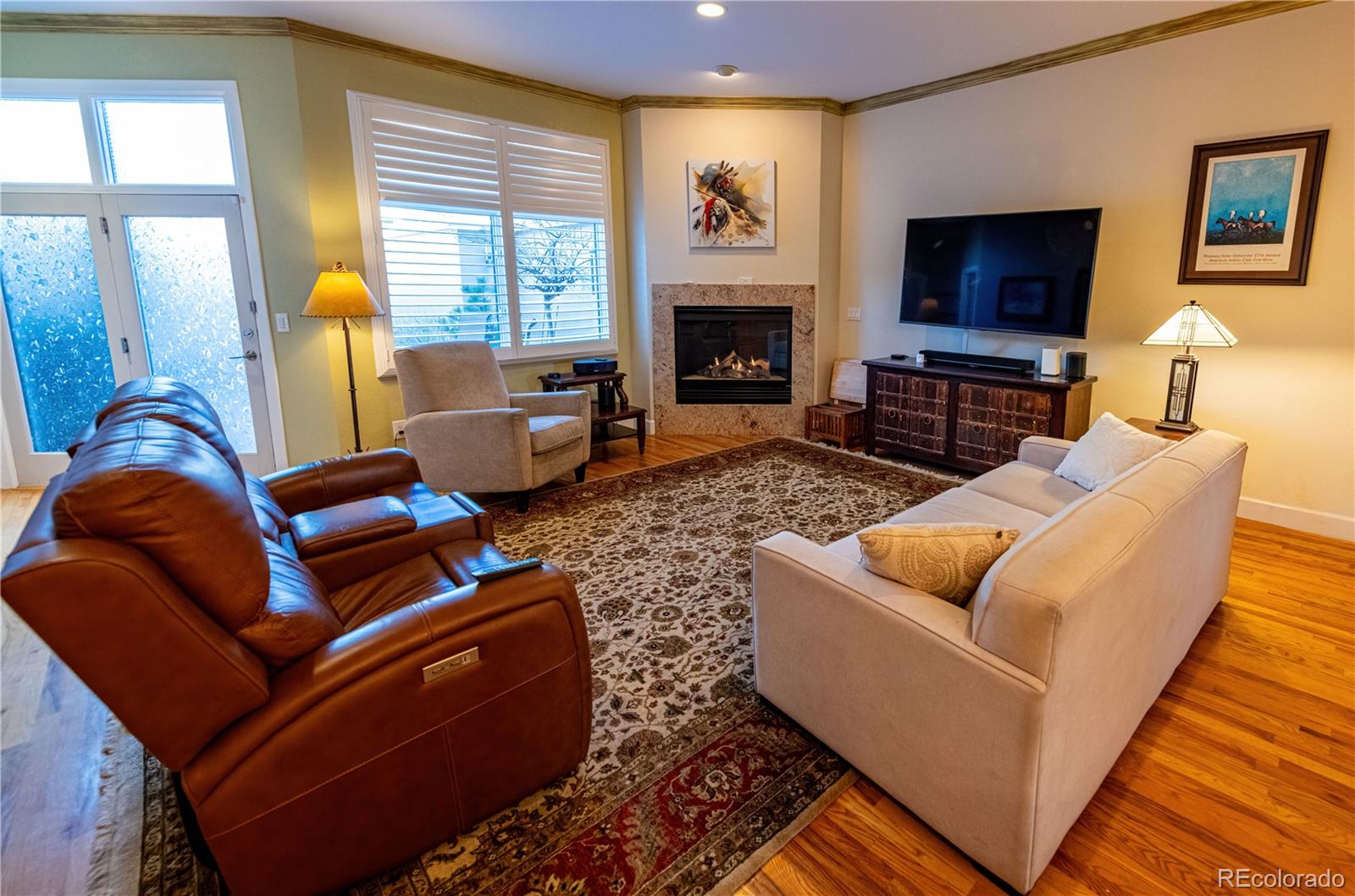566 Josephine Street Denver, CO 80206 - Photo 10 of 45 a living room with furniture a flat screen tv and a fireplace