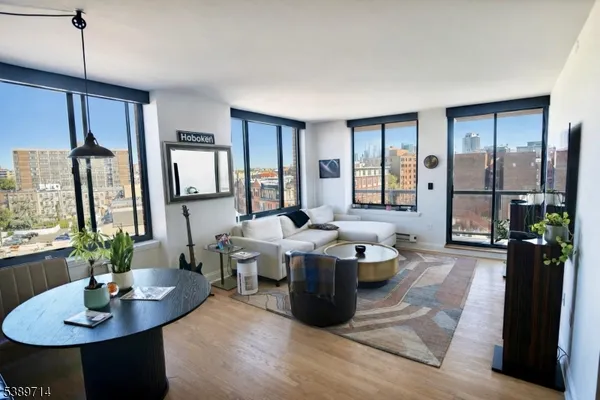 a living room with couches a table and chairs