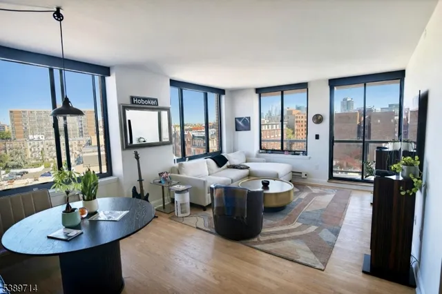 a living room with couches a table and chairs