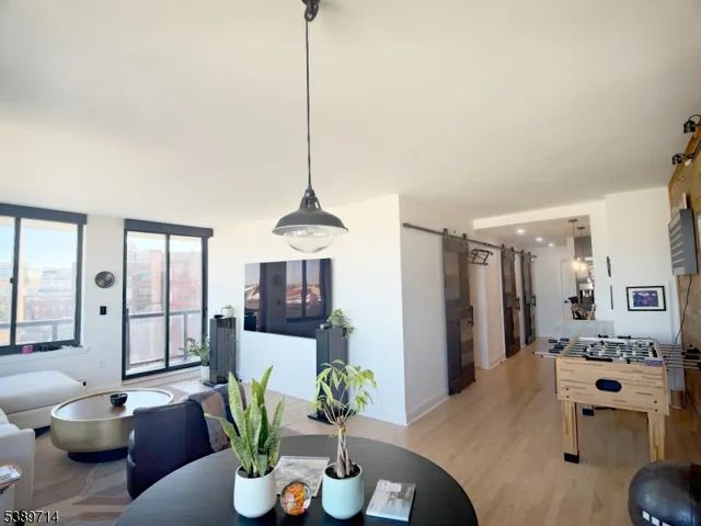 a living room with furniture a chandelier and a view