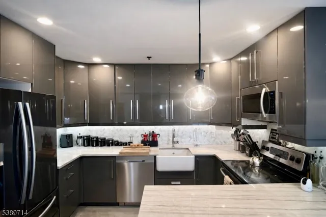 a kitchen with granite countertop a refrigerator and a stove