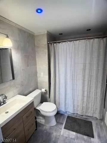 a bathroom with a toilet a sink and shower