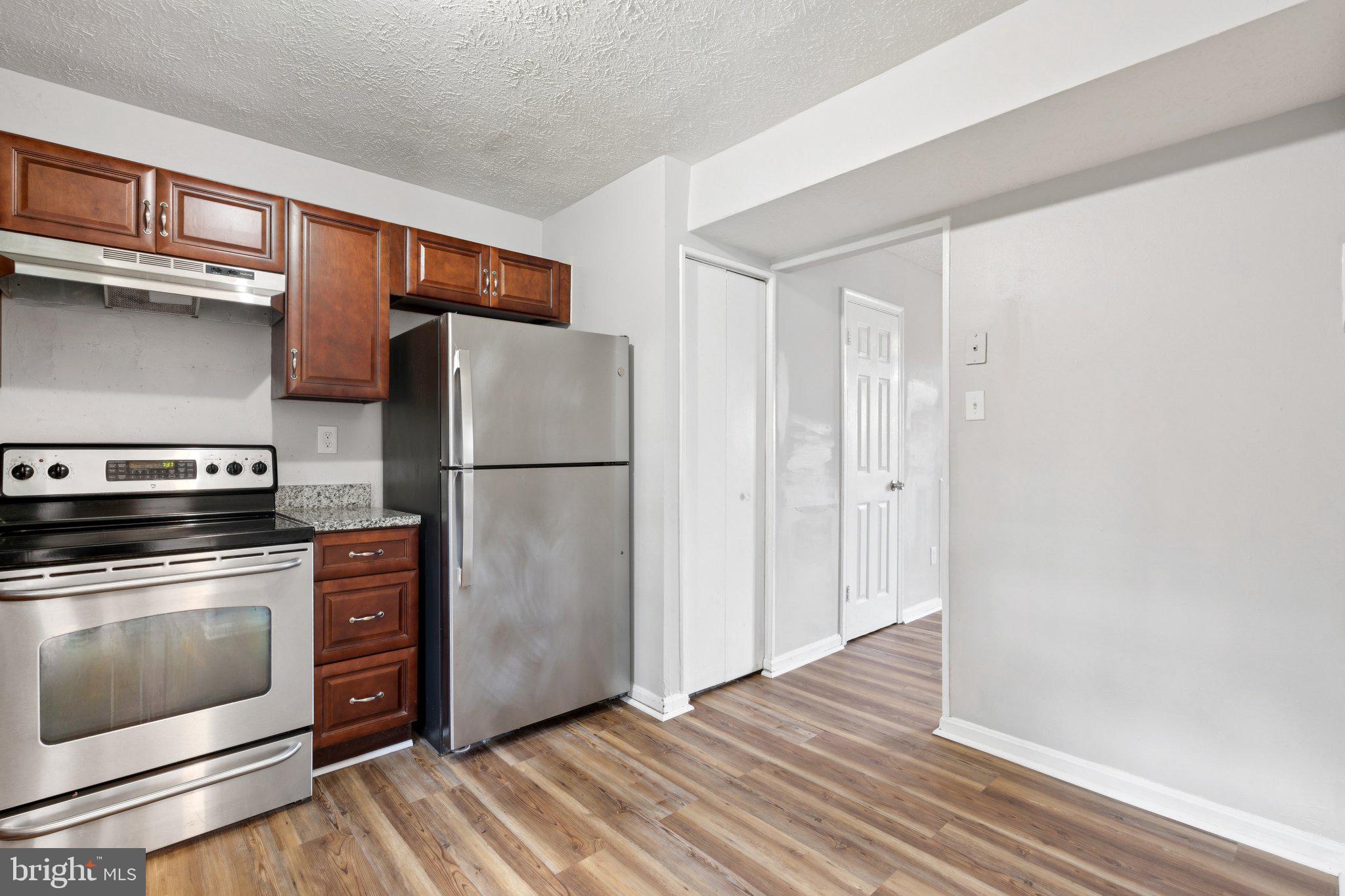 41 Dove Tree Court Indian Head, MD 20640 - Photo 10 of 23 a kitchen with a refrigerator stove and wooden floor