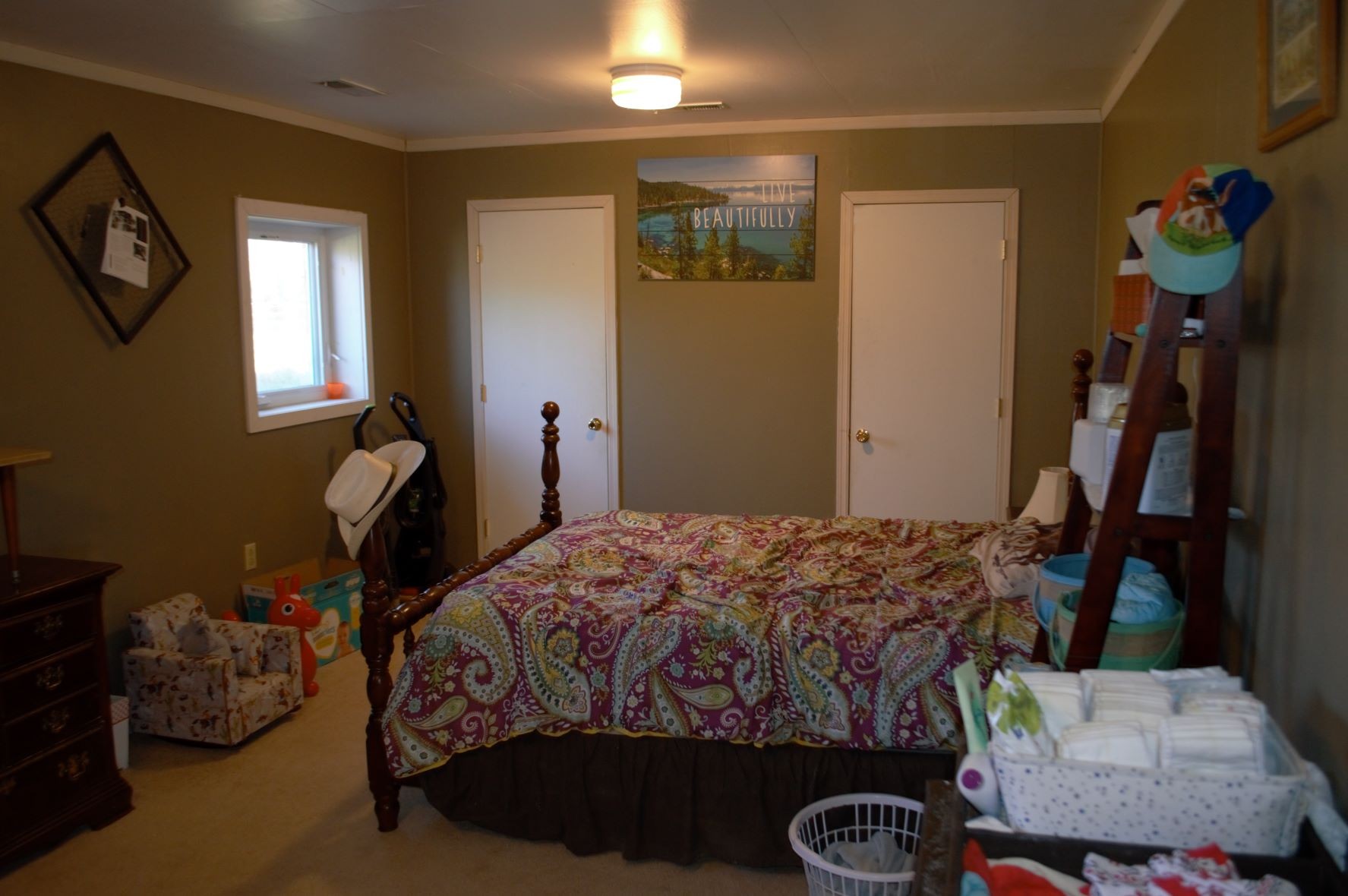 2151 Baggett Road Palmyra, TN 37142 - Photo 16 of 29 a bedroom with a bed and a chandelier