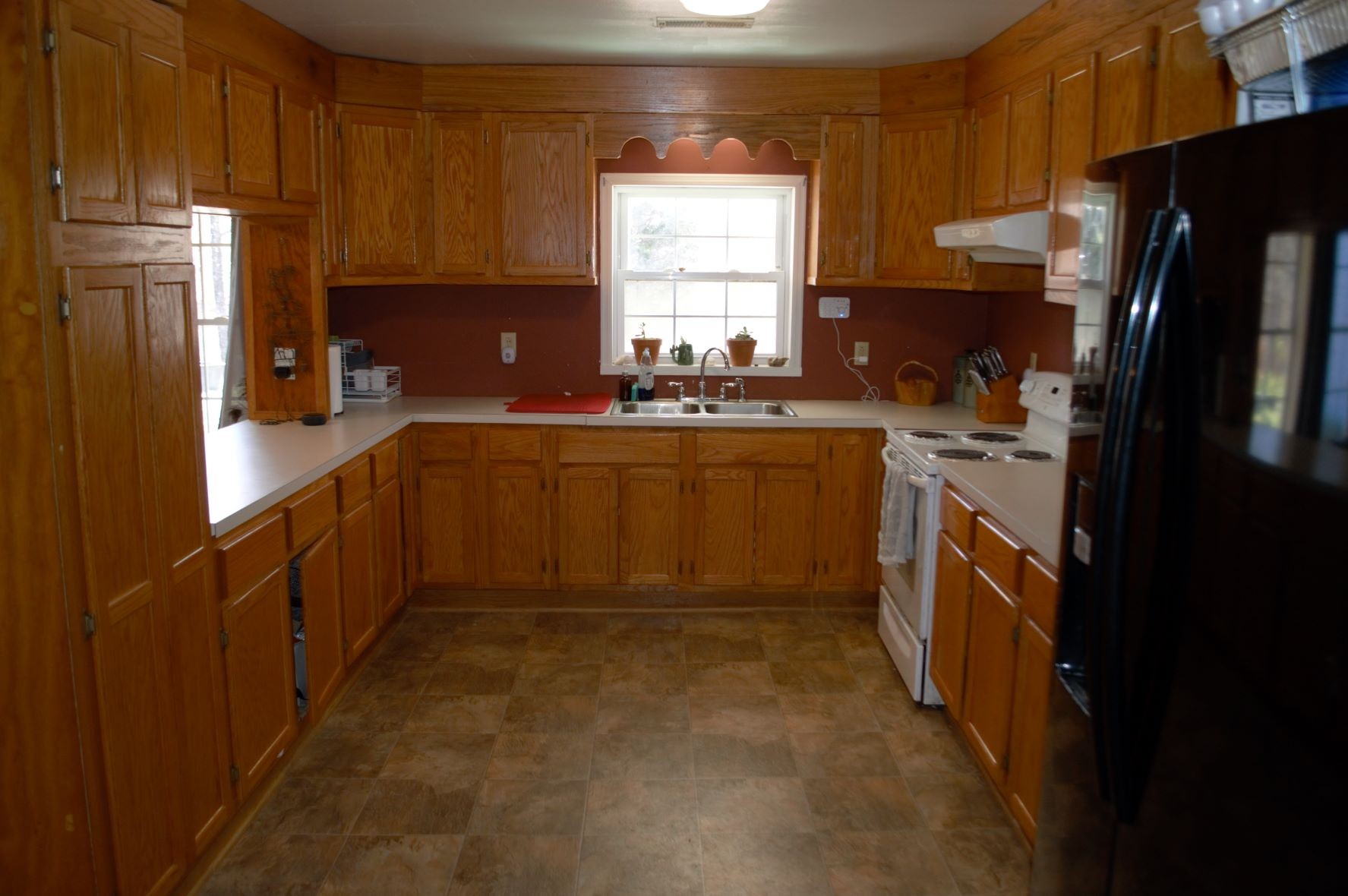 2151 Baggett Road Palmyra, TN 37142 - Photo 6 of 29 a kitchen with stainless steel appliances granite countertop a refrigerator a stove a sink dishwasher and wooden cabinets