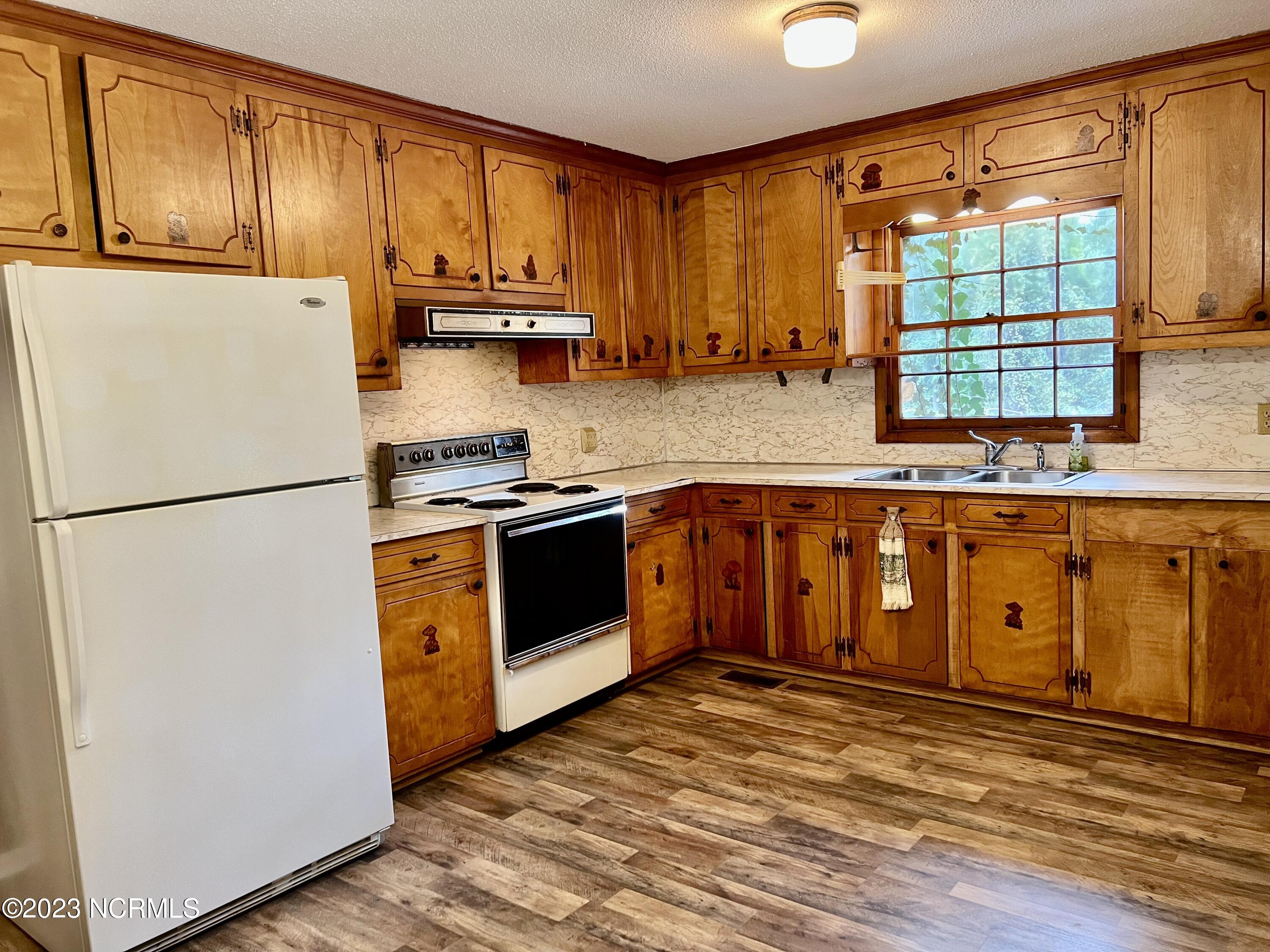 3201 Country Club Road New Bern, NC 28562 - Photo 4 of 45 Nice Sized Kitchen with Wood Cabinets and LVT Flooring