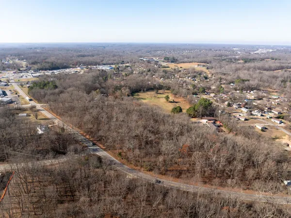 an aerial view of house with yard and mountain view in back