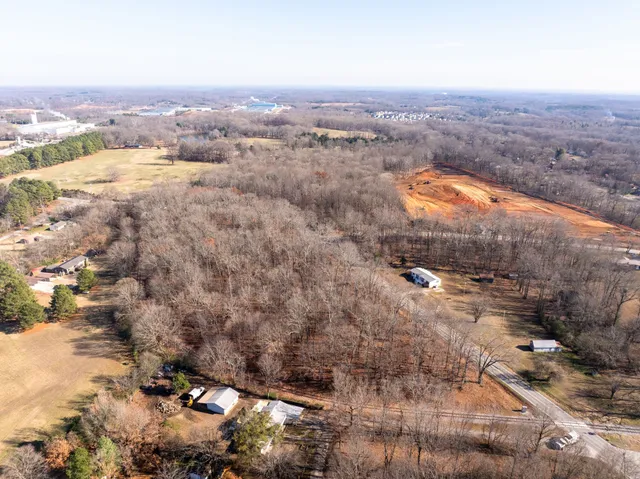 an aerial view of house with yard and mountain view in back