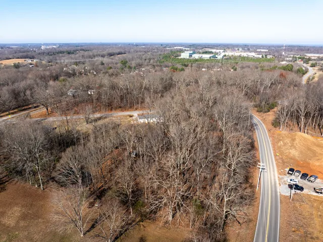 an aerial view of a house with a yard and lake view
