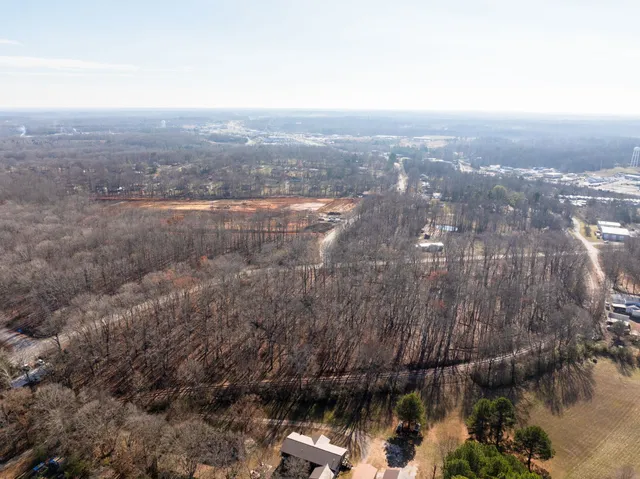 an aerial view of house with yard and mountain view in back