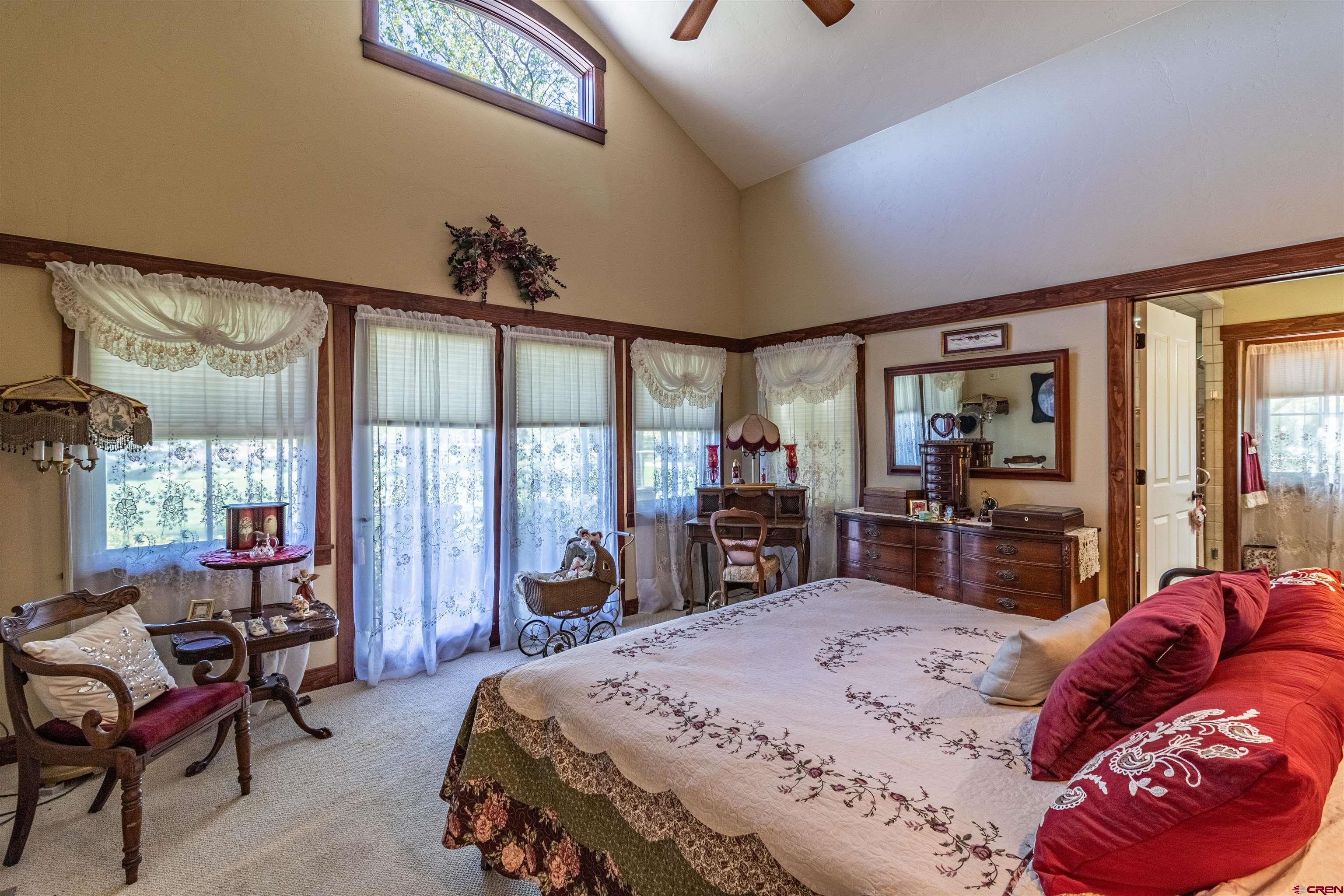 1167 North Dalton Ranch Road Durango, CO 81301 - Photo 15 of 45 a bedroom with a large bed and a large window