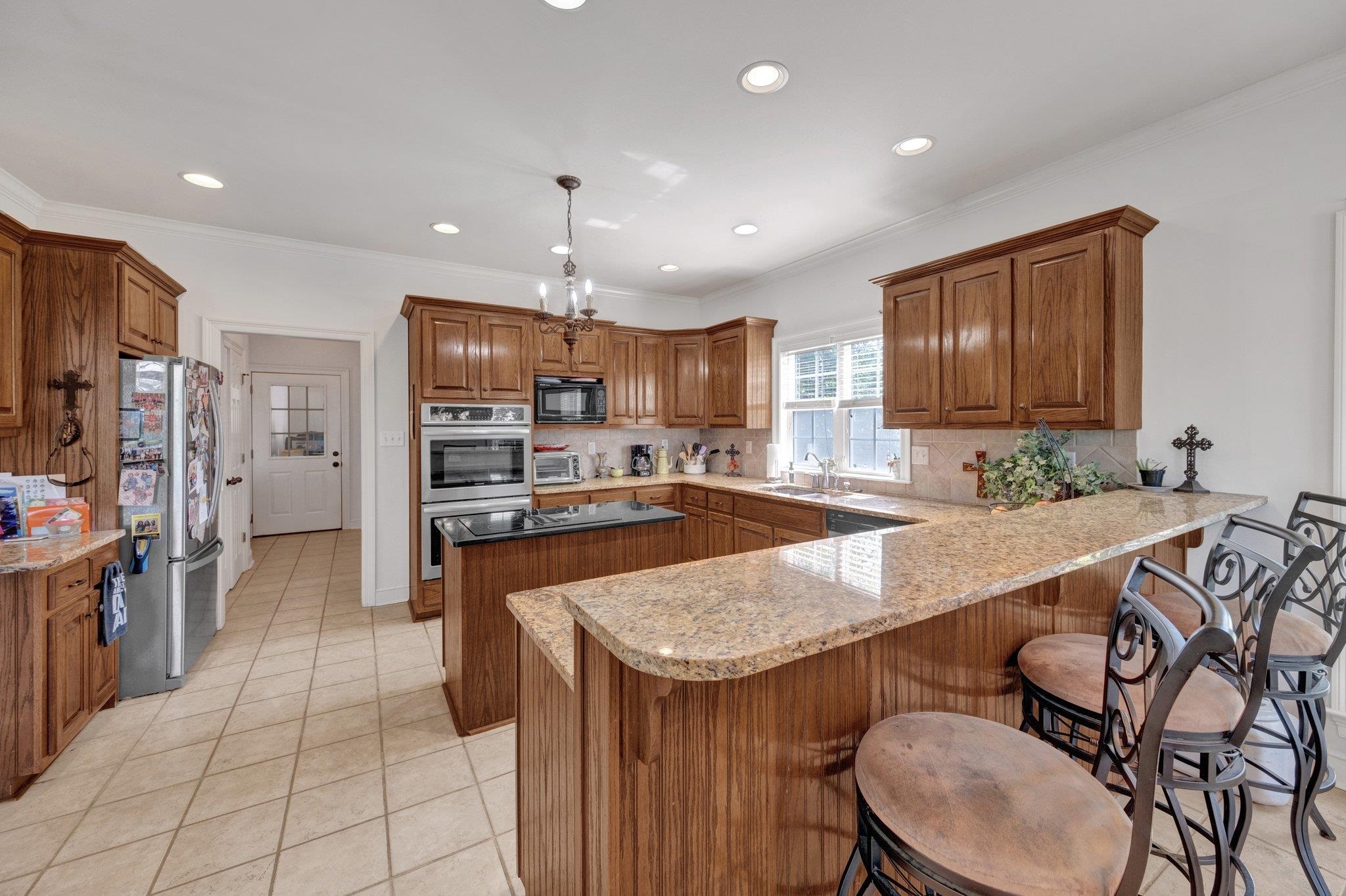 914 Beaver Creek Road Brighton, TN 38011 - Photo 12 of 38 a kitchen with stainless steel appliances granite countertop a sink a stove a refrigerator and a oven