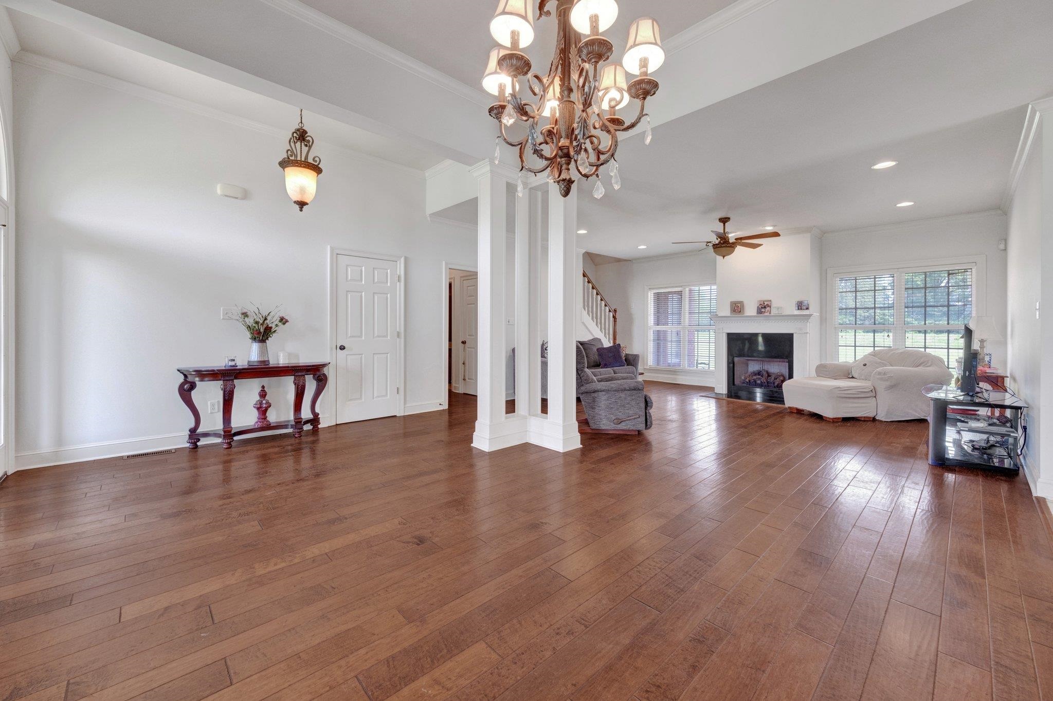 914 Beaver Creek Road Brighton, TN 38011 - Photo 18 of 38 a view of a livingroom with furniture a table wooden floor and a chandelier
