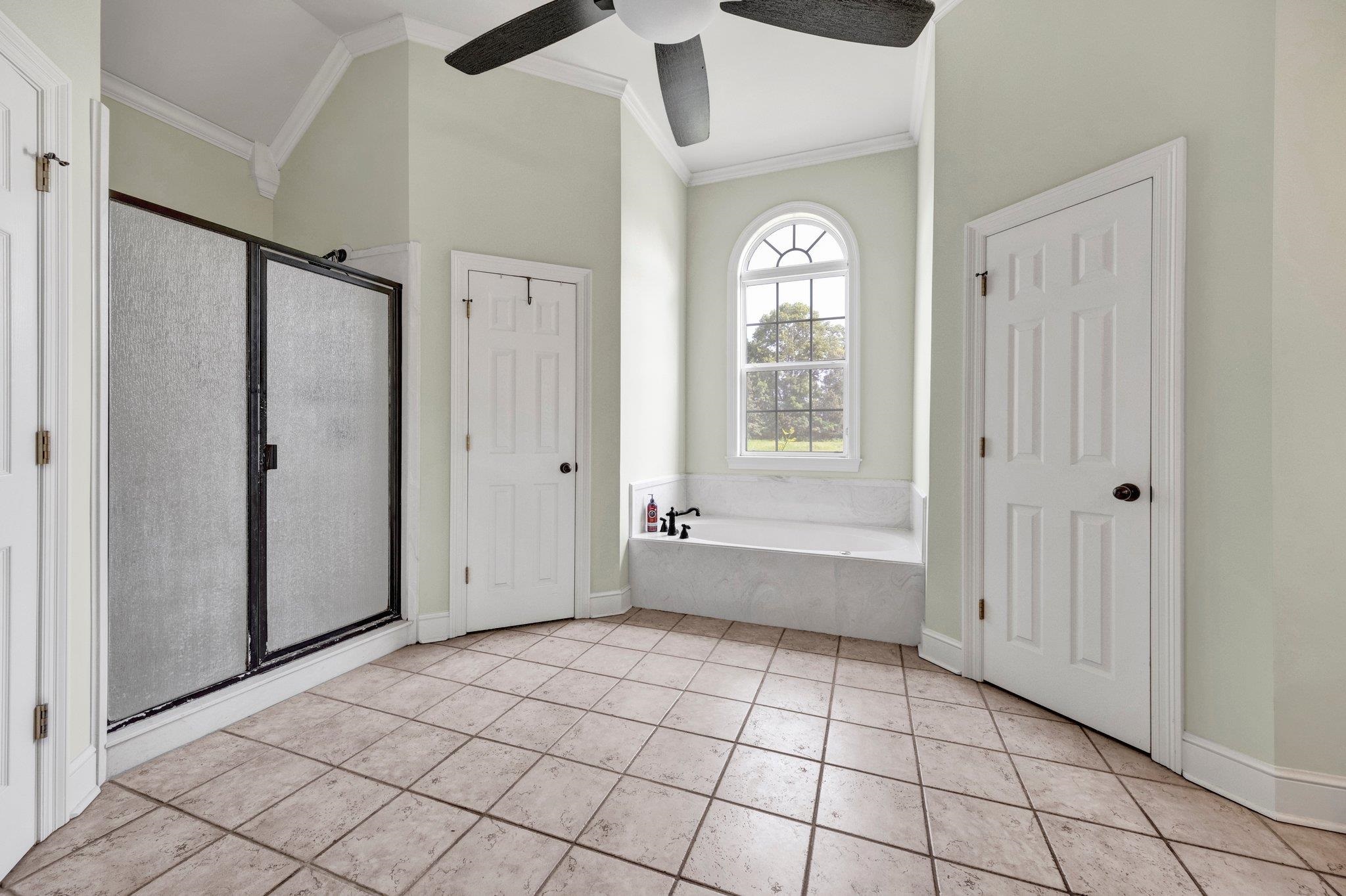 914 Beaver Creek Road Brighton, TN 38011 - Photo 7 of 38 a view of an empty room with window and chandelier fan