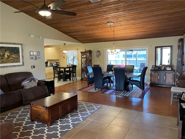 a living room with furniture and wooden floors
