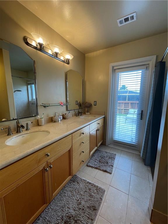 8581 Southwest 27th Place Davie, FL 33328 - Photo 9 of 10 a spacious bathroom with a double vanity sink and a mirror