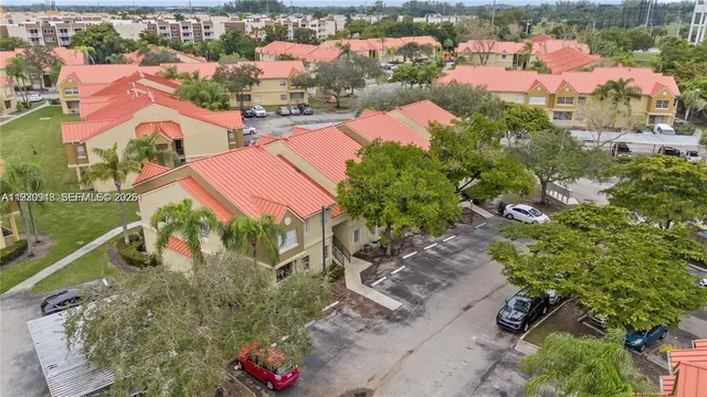 an aerial view of residential houses with outdoor space and street view