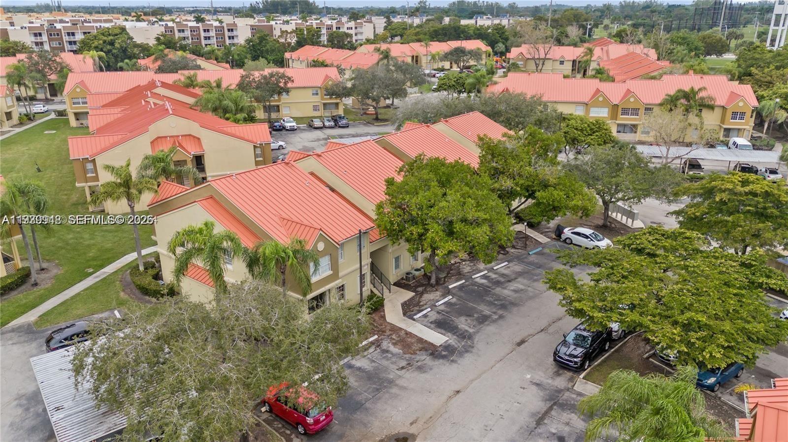 18348 Northwest 68th Avenue, Unit D Hialeah, FL 33015 - Photo 17 of 18 an aerial view of residential houses with outdoor space and street view