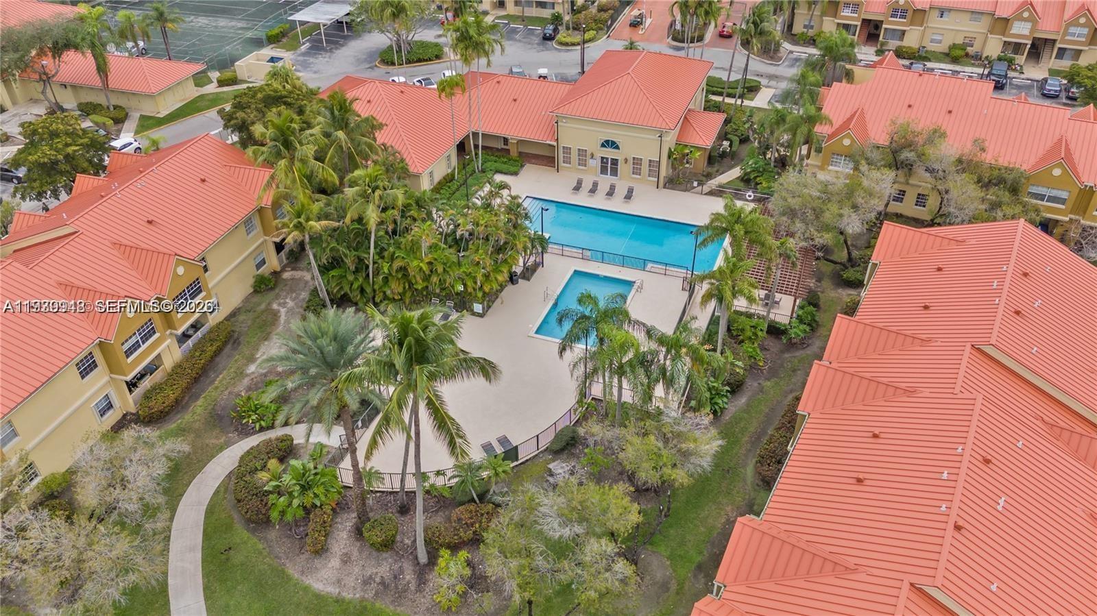 18348 Northwest 68th Avenue, Unit D Hialeah, FL 33015 - Photo 18 of 18 an aerial view of a house with a yard and garden