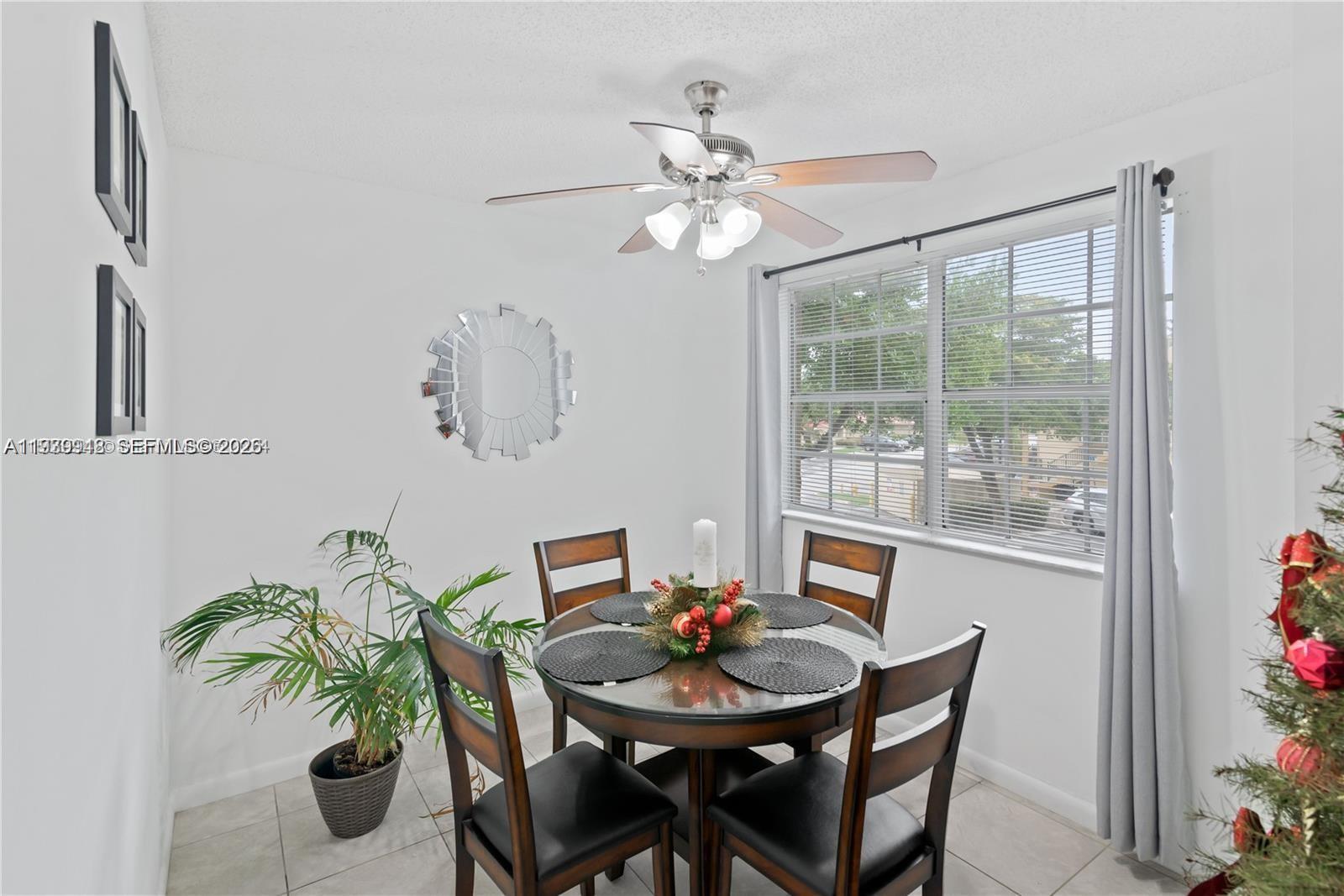 18348 Northwest 68th Avenue, Unit D Hialeah, FL 33015 - Photo 8 of 18 a view of a dining room with furniture and a potted plant
