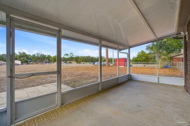 a view of an empty room with a floor to ceiling window