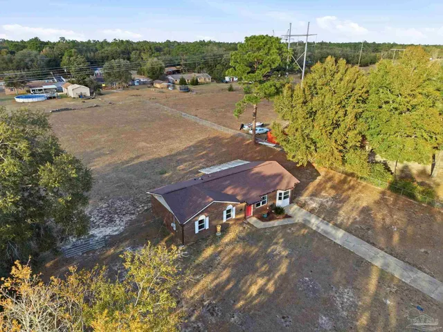 an aerial view of residential houses with outdoor space