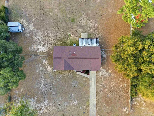 an aerial view of a house with outdoor space