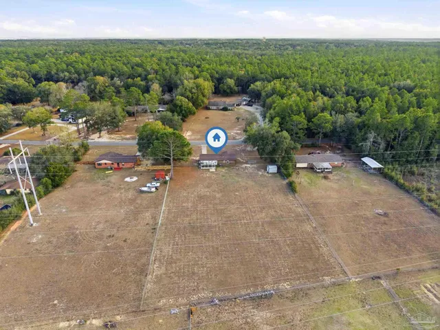 an aerial view of a house with a yard