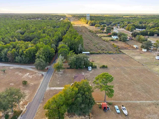 a view of a house with backyard and glass windows