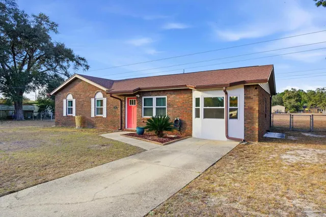 a view of empty room with window and wooden floor