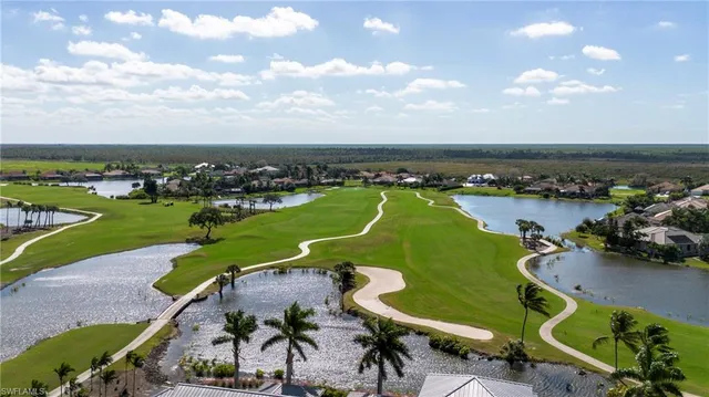 an aerial view of a with a swimming pool a patio and lake view