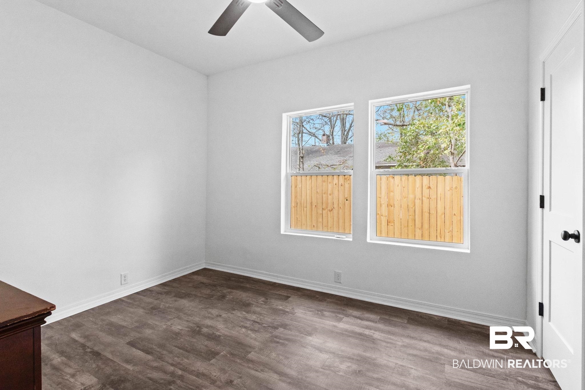 128 Bush Avenue Mobile, AL 36604 - Photo 25 of 40 Unfurnished room with dark wood-style floors and ceiling fan