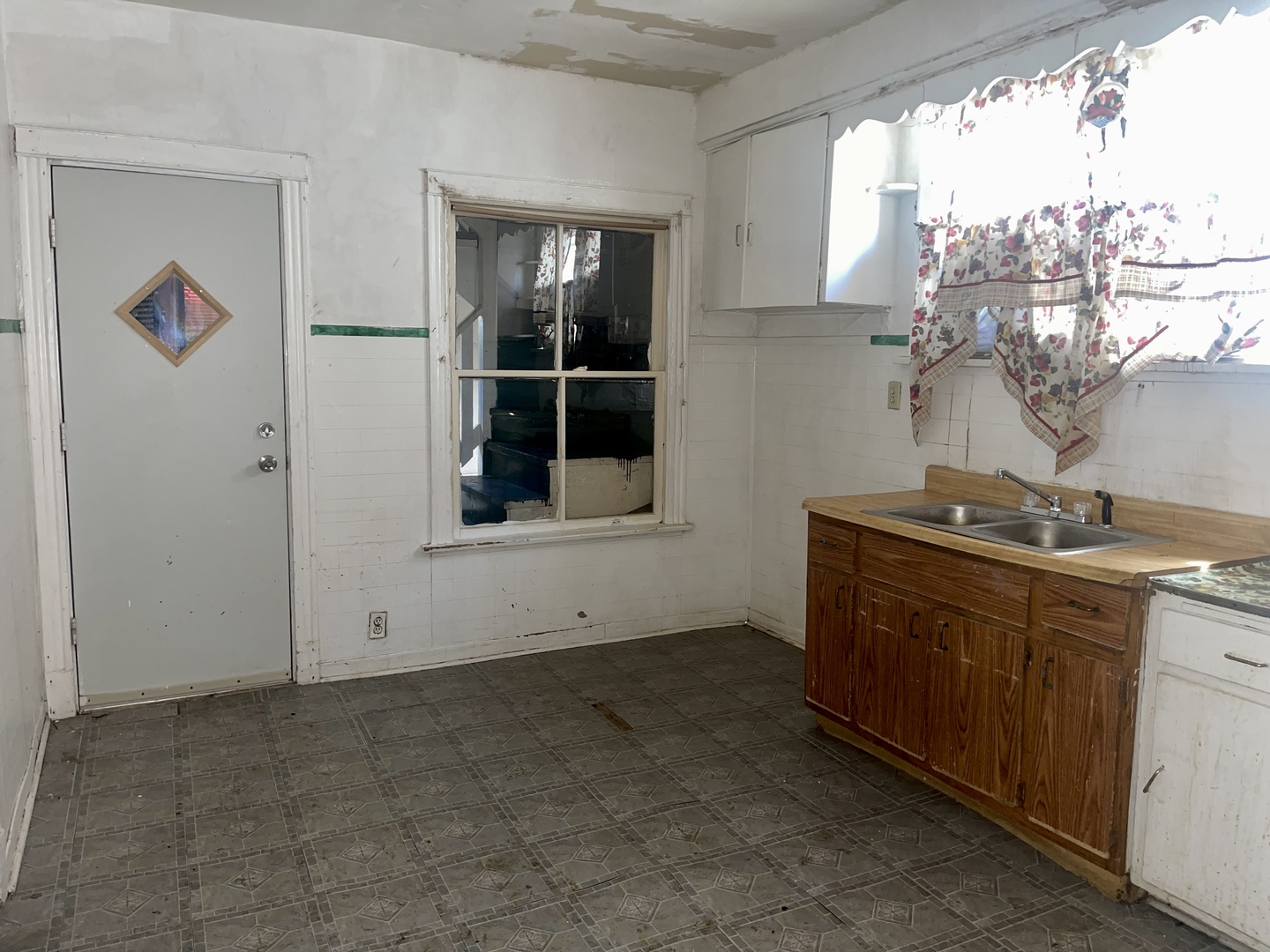 7017 South Wood Street Chicago, IL 60636 - Photo 11 of 25 a view of cabinets a sink and a window in a room