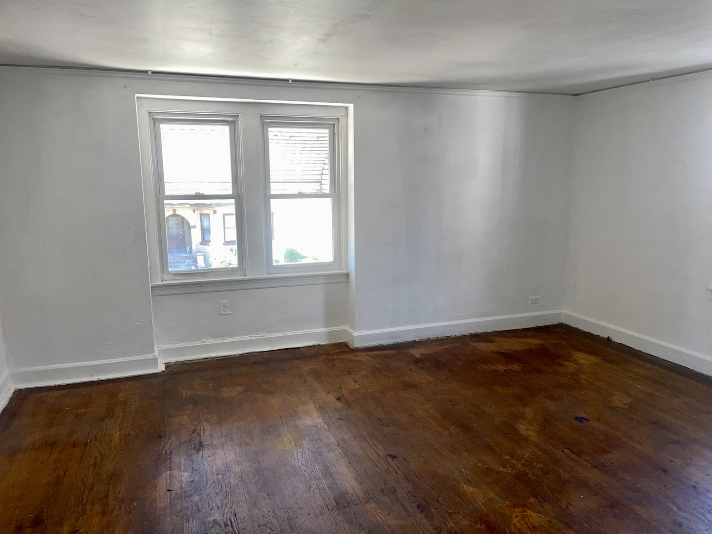 7017 South Wood Street Chicago, IL 60636 - Photo 14 of 25 an empty room with wooden floor and windows