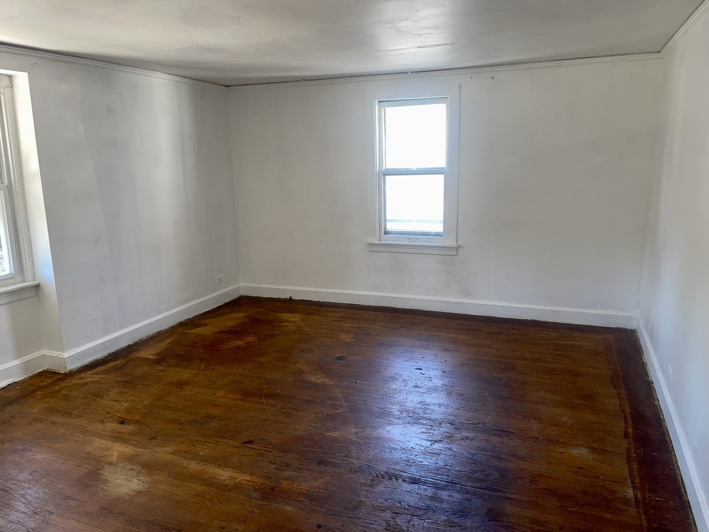 7017 South Wood Street Chicago, IL 60636 - Photo 15 of 25 an empty room with wooden floor and windows
