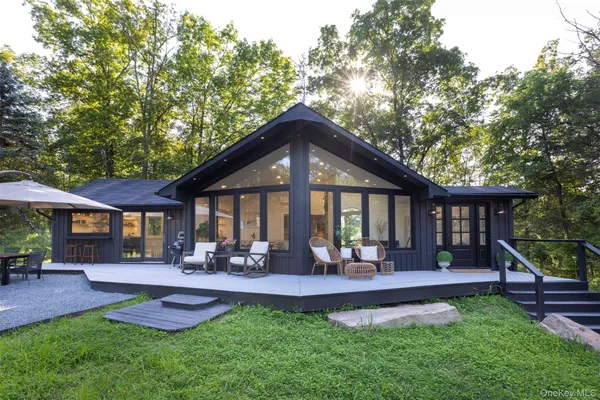 a front view of a house with yard and green space